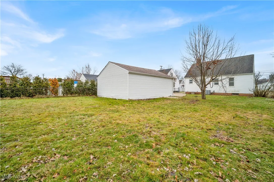 View of yard with an outbuilding and fence