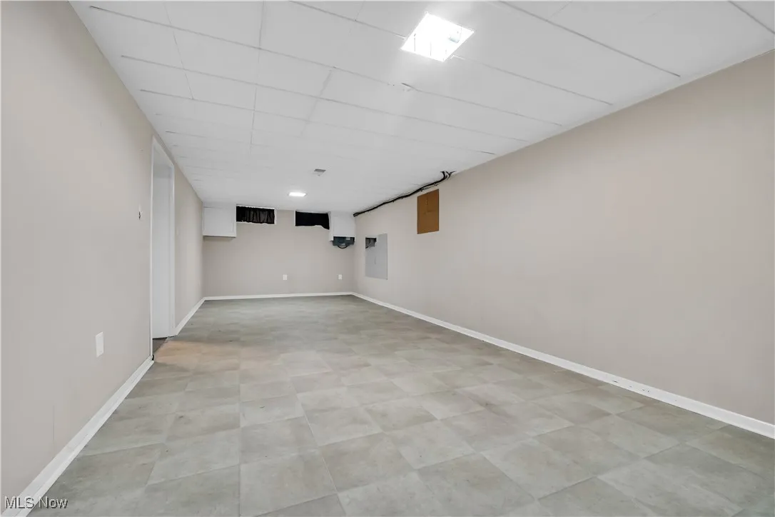 Finished below grade area with baseboards and a drop ceiling