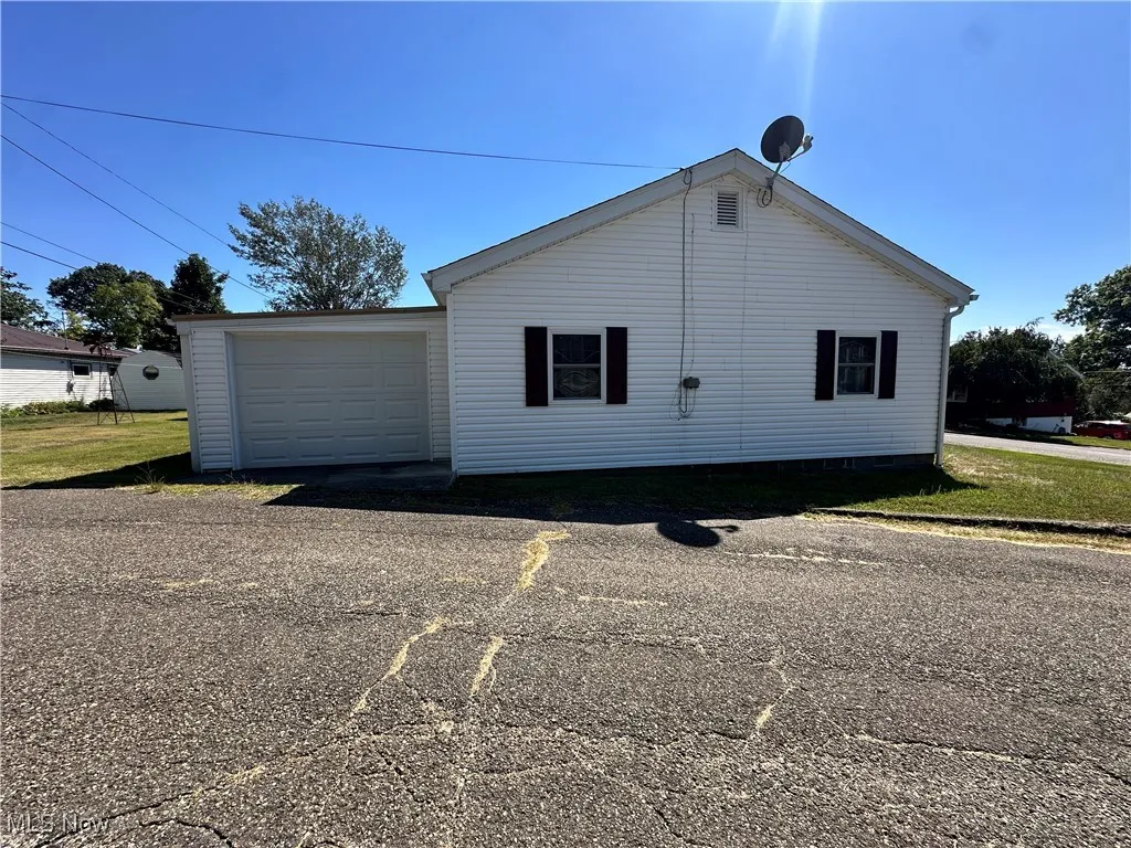 Side view of home featuring back garage entrance