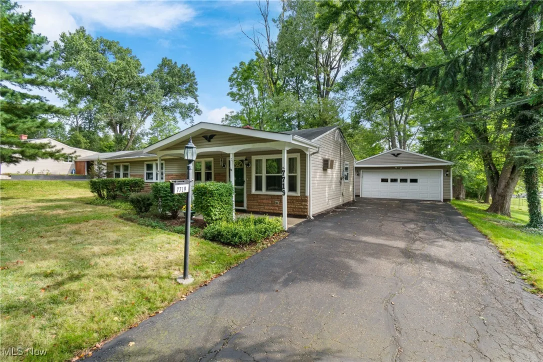 View of right side of the home and the 2-car garage and paved driveway
