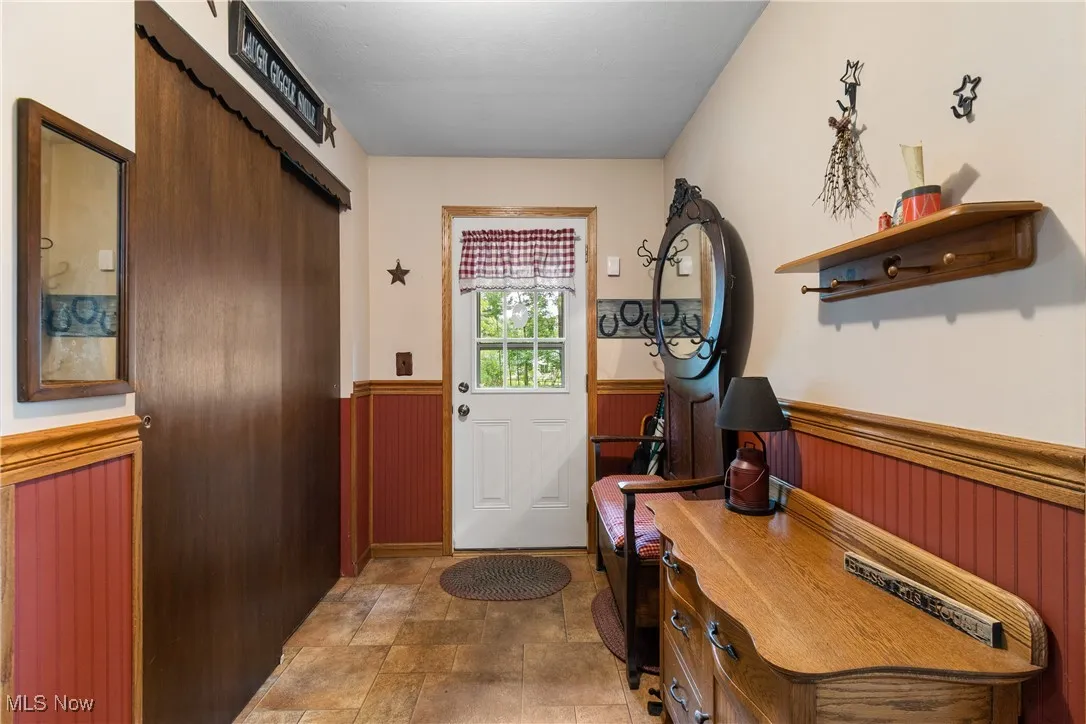 Mudroom with closet and door to the backyard