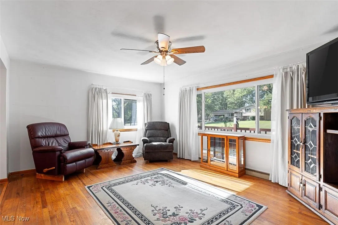 Living room featuring light wood-style floors and ceiling fan