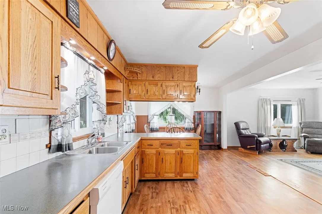 Kitchen featuring light wood-type flooring, open floor plan, plenty of natural light, and white dishwasher
