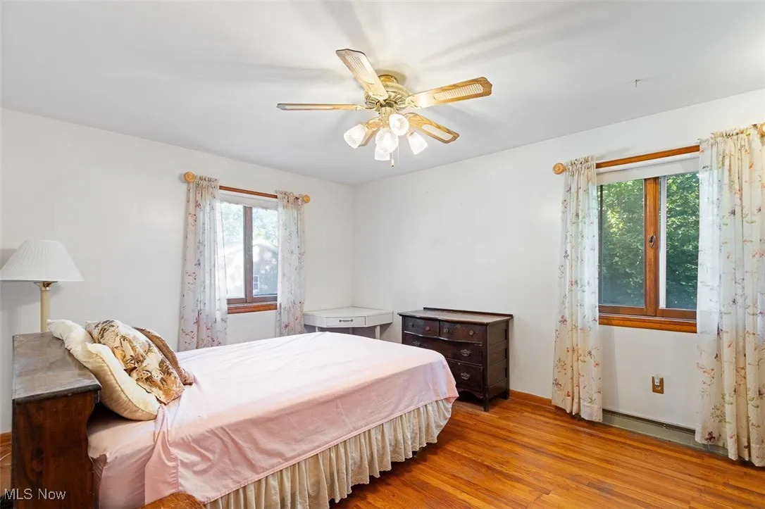 Bedroom with wood finished floors and ceiling fan