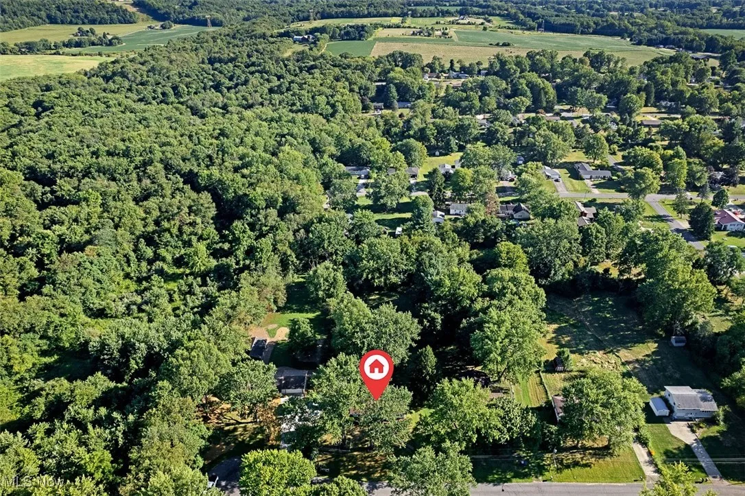 View of property location featuring a forest