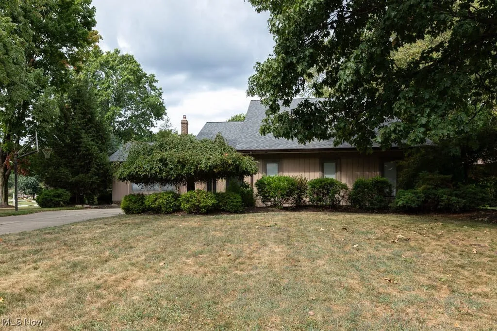 View of front of property featuring a front lawn and a chimney