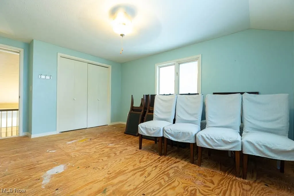 Living area featuring light wood-style floors and baseboards