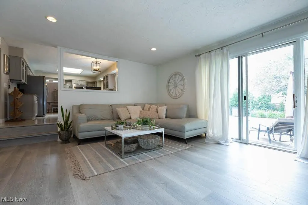 Living area with wood finished floors and recessed lighting
