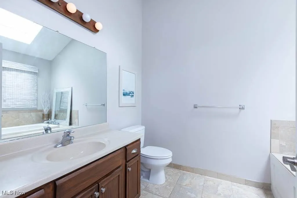 Bathroom with a skylight and vanity