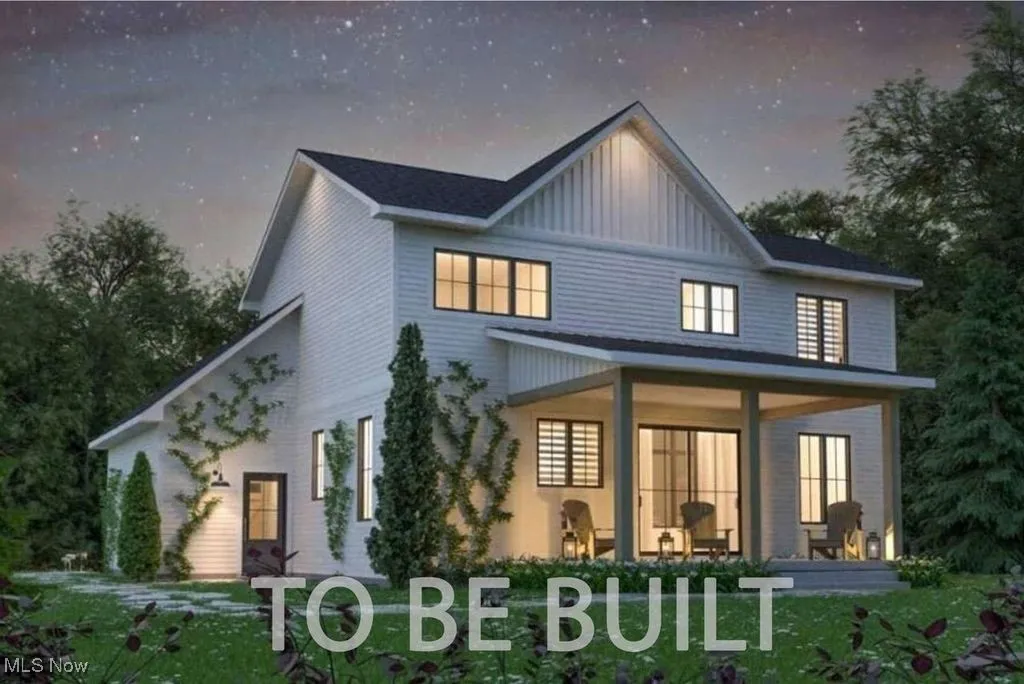 Back of property with covered porch and board and batten siding