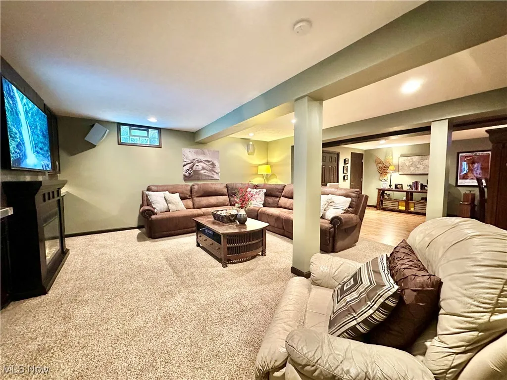 Living room featuring a fireplace, light colored carpet, and recessed lighting