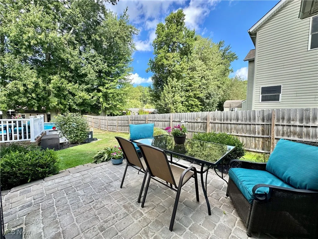 Fenced backyard with outdoor dining space and a patio
