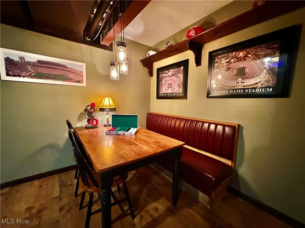 Dining space featuring baseboards and dark wood-style floors
