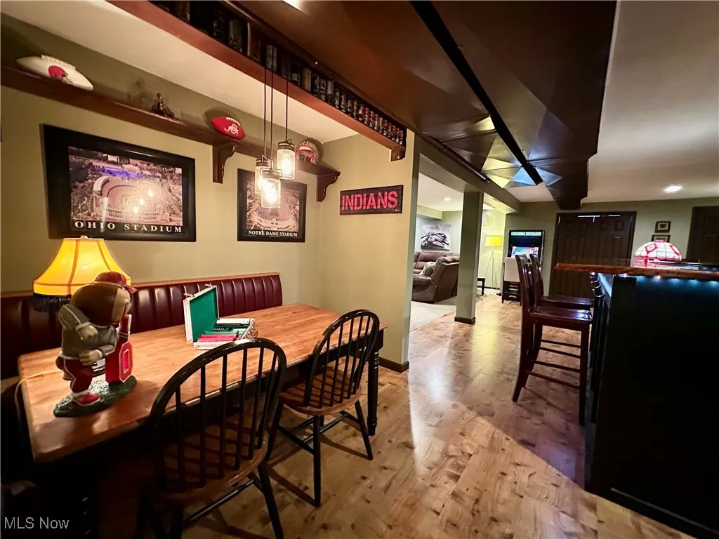 Dining area with light wood-style flooring and recessed lighting