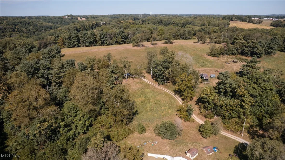 View of property location featuring a forest