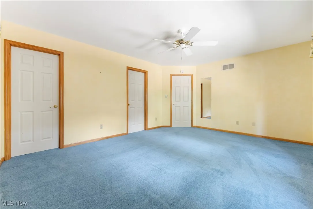 Unfurnished bedroom featuring carpet and ceiling fan