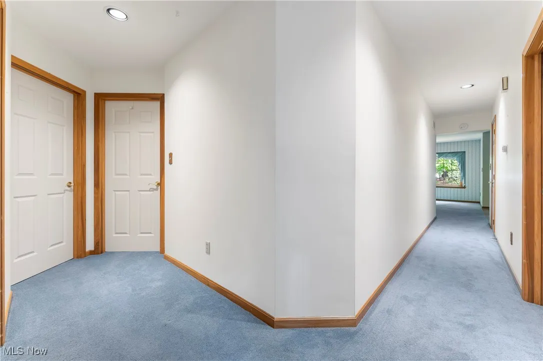 Corridor with carpet floors and recessed lighting