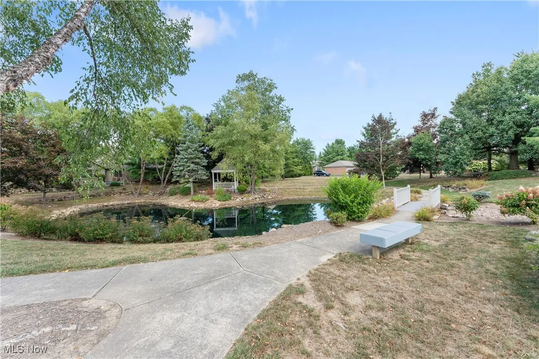 View of community with a lawn and view of scattered trees