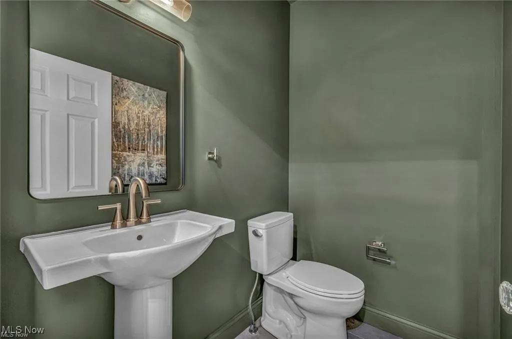 Bathroom with toilet and tile patterned floors
