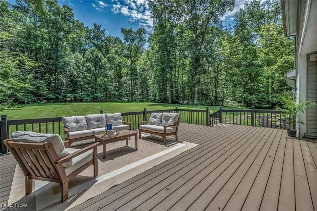 Wooden terrace with an outdoor hangout area and a yard