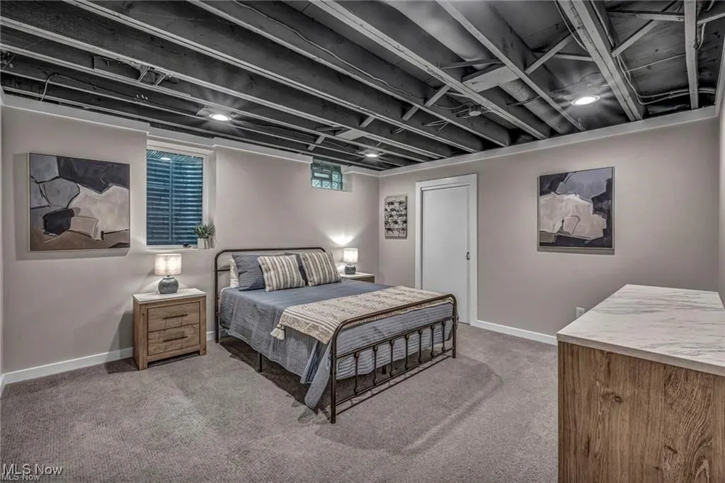 Carpeted bedroom with baseboards