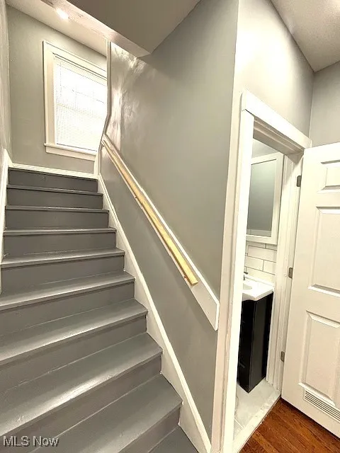 Staircase featuring wood finished floors