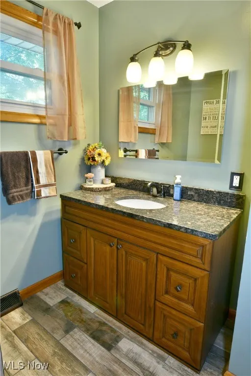 Bathroom featuring vanity and light wood-style flooring