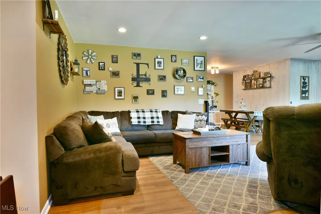 Living room with light wood-style flooring and recessed lighting
