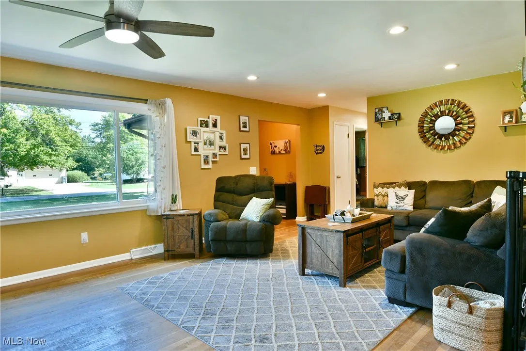 Living area featuring wood finished floors, recessed lighting, and a ceiling fan