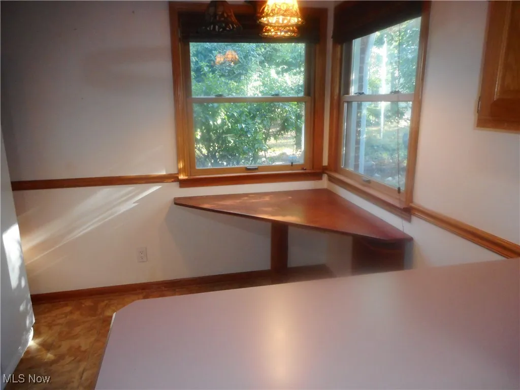 Unfurnished dining area with baseboards