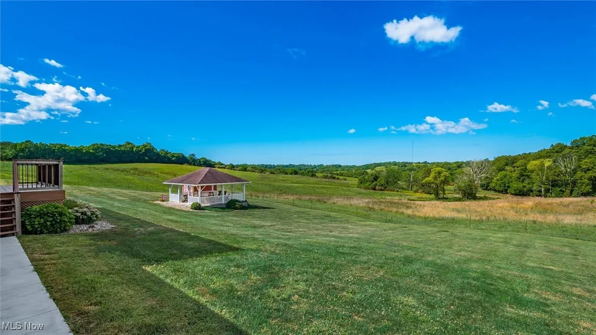 View of grassy yard with a gazebo and a view of countryside