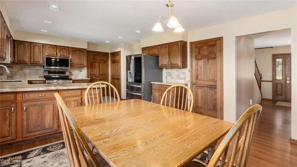Dining room featuring light wood-style flooring and recessed lighting