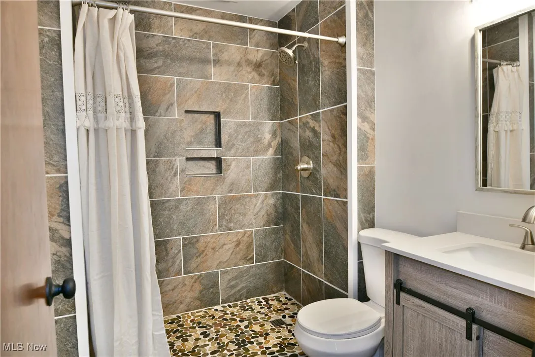 Full bathroom featuring vanity and a stall shower