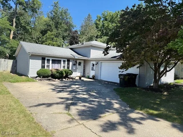 View of front facade with driveway and a garage