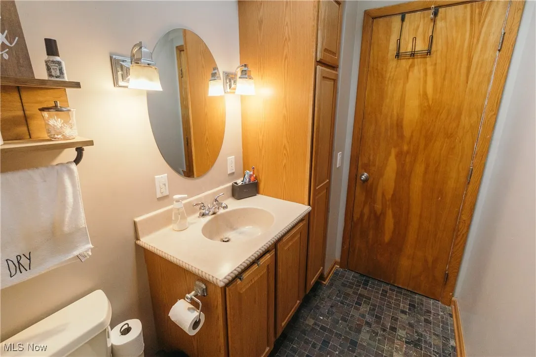 Half bath featuring vanity and toilet