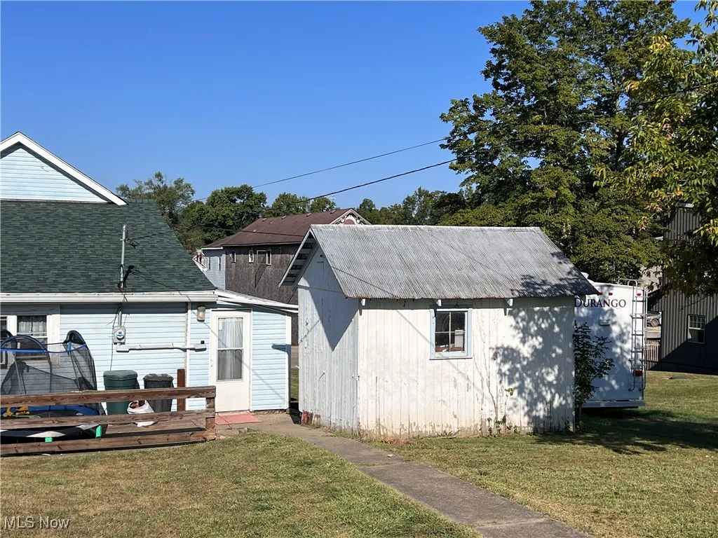 View of outbuilding with a trampoline
