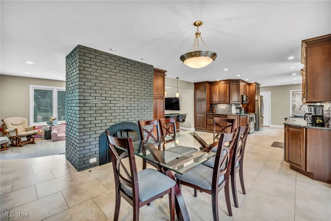 Dining space featuring recessed lighting and light tile patterned floors