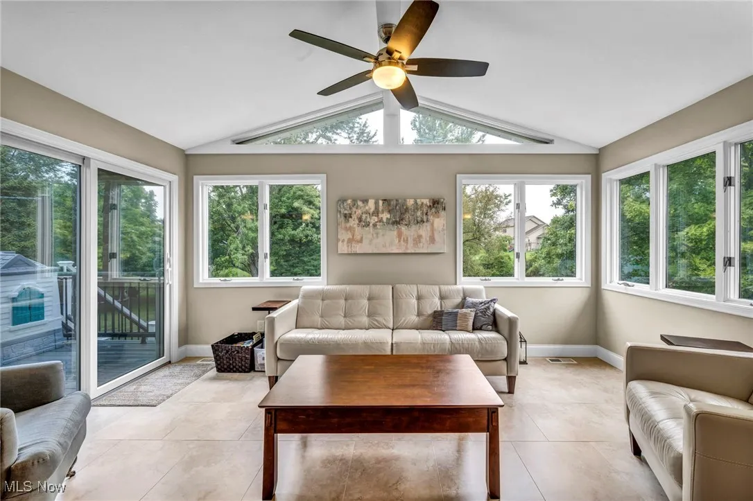 Sunroom with vaulted ceiling and tile patterned floors