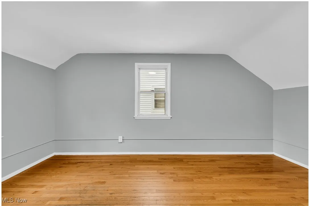 Bonus room featuring light wood finished floors and lofted ceiling