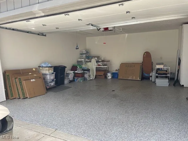 View of garage with new flooring in 2024