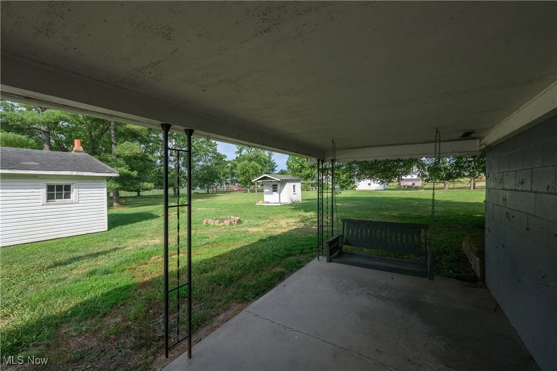 View of patio featuring a storage shed