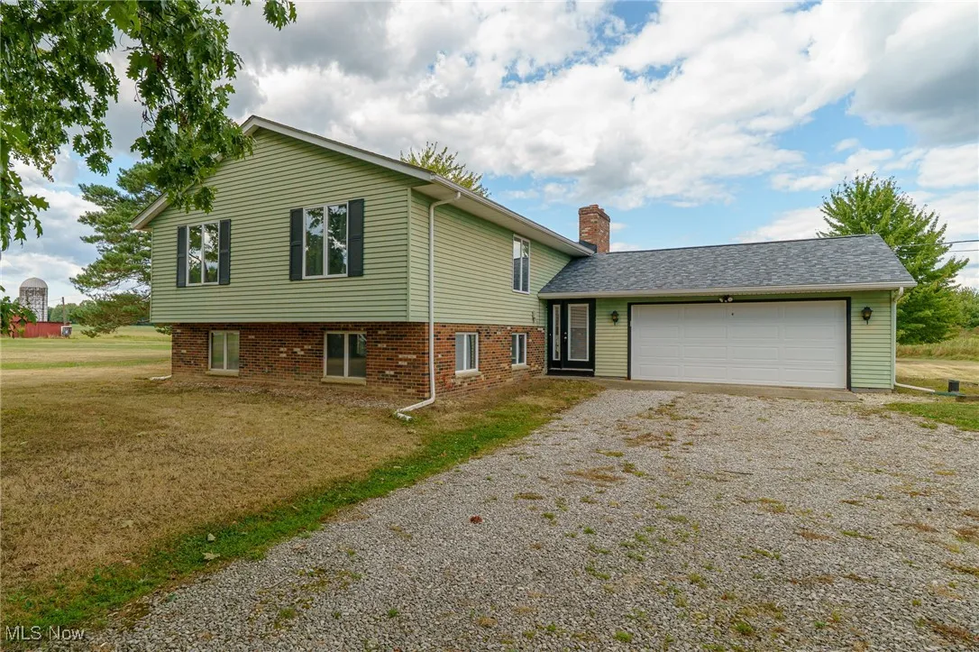 Front view of property showing new entry door and oversized 2 car garage