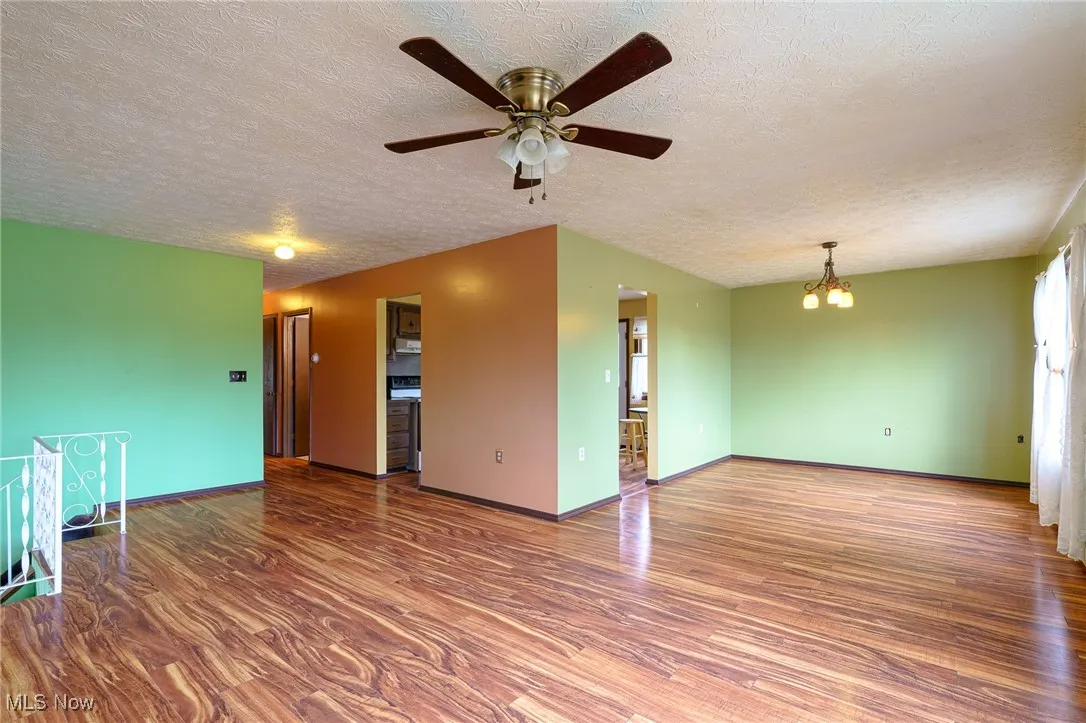 Living room showing large dining room and entrances to kitchen