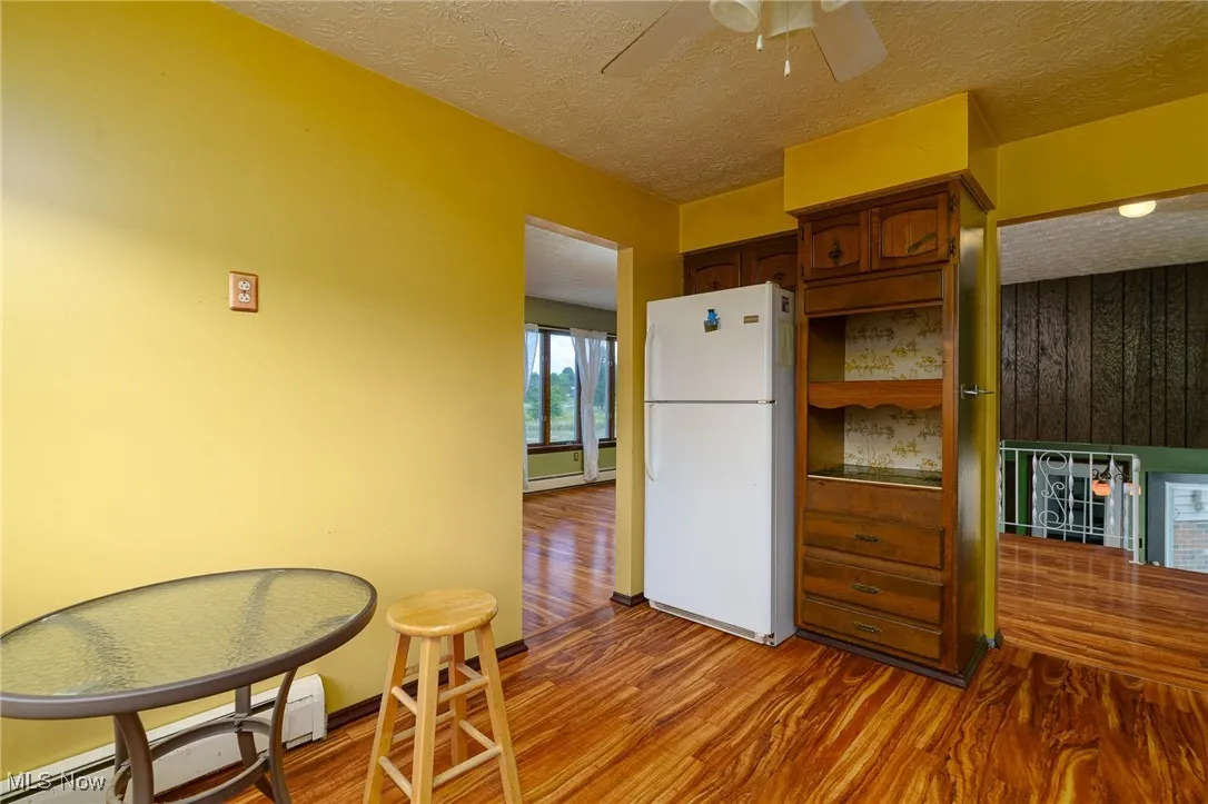 Kitchen featuring white appliances and entrance to dining room