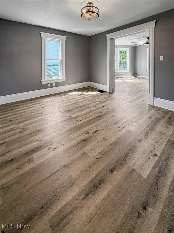 Unfurnished room featuring wood finished floors and a textured ceiling