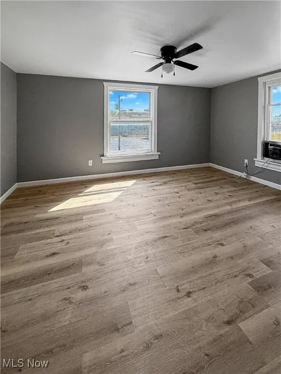 Spare room featuring light wood-type flooring and a ceiling fan