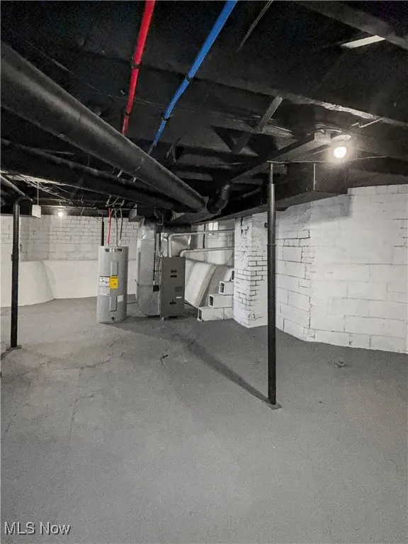 Unfinished basement with water heater and heating unit