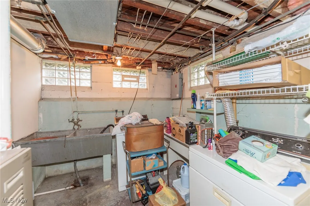 Below grade area featuring washing machine and clothes dryer and electric panel