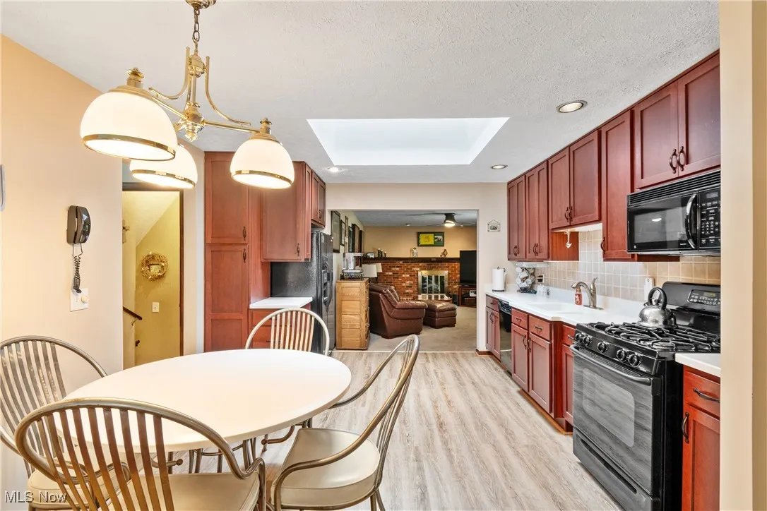Updated kitchen with solid cherry cabinetry and new LVP floors.