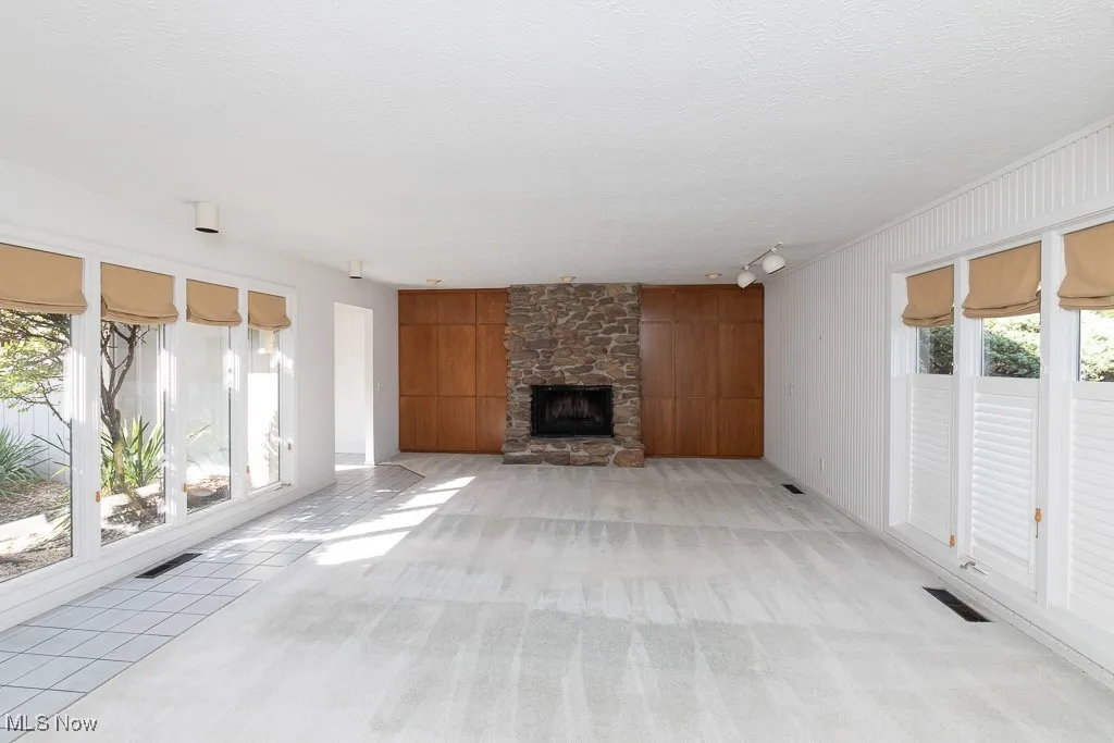 Gorgeous living room with built in wetbar, a fireplace and tons of natural light.
